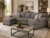 Gray sectional sofa in a living room with a coffee table and decorative items.