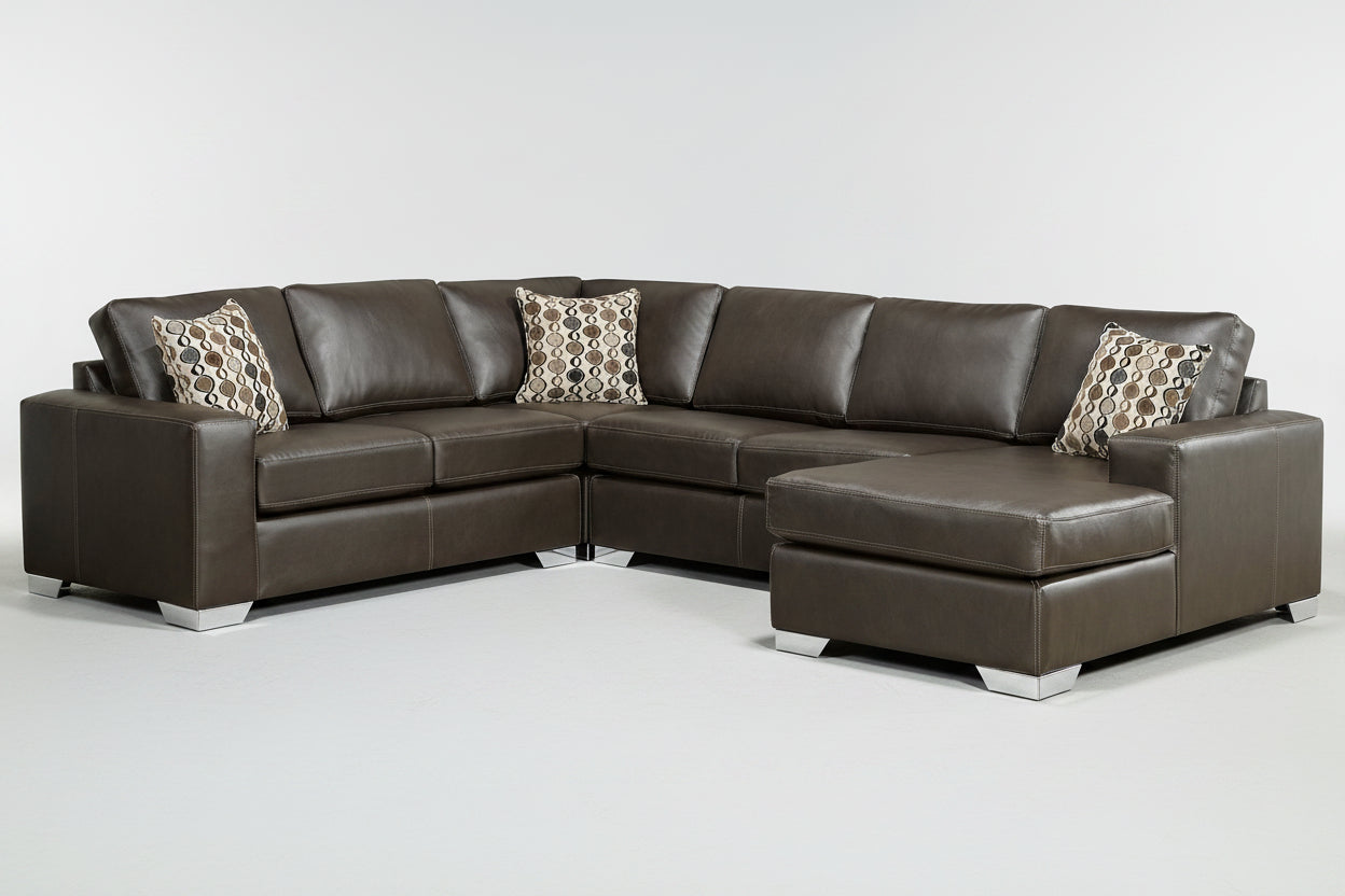 A brown leather sectional sofa with a chaise, loveseat, and sofa arranged in an L-shape, featuring patterned throw pillows.