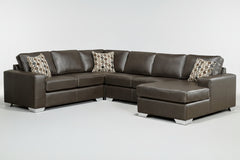 A brown leather sectional sofa with a chaise, loveseat, and sofa arranged in an L-shape, featuring patterned throw pillows.